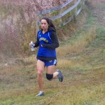Mariner XC varsity runner Molly Mitchell powers through Saturday’s rainy, windy and snowy weather. -Photo by McKibben Jackinsky, Homer News