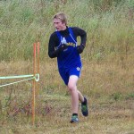 Mariner XC varsity runner Brandon Beachy powers through Saturday’s rainy, windy and snowy weather. -Photo by McKibben Jackinsky, Homer News