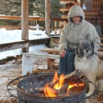 Valerie Young-Williams and her canine companion Matanuska enjoy the warmth of the bonfire at Center for Alaskan Coastal Studies’ Wynn Nature Center on Sunday.-Photo by McKibben Jackinsky, Homer News