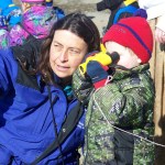 Carmen Field, a marine educator with Kachemak Bay Research Reserve, helps Gavin Smith locate Beluga Slough wildlife during “Family Wetland Exploration,” a Week of the Young Child event, on April 19. The focus also is on children at the Safe Kids Fair, held at the Homer High School commons on Saturday. See related story, page 2.-Photo by McKibben Jackinsky, Homer News