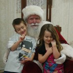 Finnegan Mattingly, left, and Diana Mattingly pose for a photograph with Santa Claus at the Nutcracker Faire last Saturday.-Photo by Michael Armstrong, Homer News