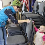 Olivia Pitzman, 1, gets a little help at the Saturday Easter Egg hunt at American Legion Post 16.-McKibben Jackinsky