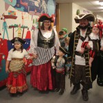 Paul Banks Elementary music teacher Tina Moore poses with her family in matching pirate costumes.-Photo by Katy Countiss