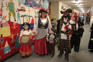 Paul Banks Elementary music teacher Tina Moore poses with her family in matching pirate costumes.-Photo by Katy Countiss