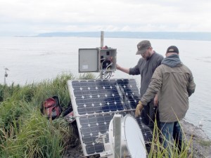 Josh Reynolds, right, from SpitwSpots, and Jason Sodergren, left, work on the Pratt Museum’s GullCam on Gull Island last month. The Alaska State Museum gave the Pratt a grant to upgrade its remote viewing camera. The camera is offline while the upgrade is being completed.-Photo by Scott Bartlett, Pratt Museum