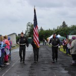 Each of them cancer survivors, a three-member honor guard from Veterans of Foreign Wars Post 10221 in Anchor Point complete the first lap of the Homer Middle School track.-Photo by McKibben Jackinsky, Homer News