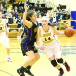 Madison Akers runs the ball to the basket, blocking an attempt at the ball by a Bristol Bay player, in the Feb. 12 Winter Carnival Tournament game.-Photo by Anna Frost, Homer News