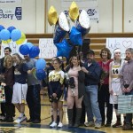 Mariner girls and boys basketball and cheerleader seniors Desiree Cleary, Aurora Waclawski, Samantha Draves, Kayla Stafford, Jadzia Martin, Breeanna Torsen, Madison Akers, Johann Kallelid and Grace Kann, left to right, pose with their parents in between the boys and girls varsity basketball games on Feb. 26. All the seniors were recognized for their athletic careers at senior night and received gifts from their teams.-Photo by Anna Frost, Homer News