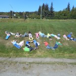 Students in Wendy Todd’s first-grade class at Paul Banks Elementary School use their bodies to spell out “thank you” after a visit to the Kenai Peninsula Fair in Ninilchik. The students wrote the following thank-you letter: Thank you for letting us go to the fair.  We liked the Legos and ribbons that 4H club showed us.  We loved seeing the animals, especially petting the alligator and visiting the parrot.  The picnic with the cool music was awesome.  Thank you for letting us make the candles out of beeswax. We especially enjoyed the pig races. We really loved everything we did there, including the cotton candy you gave us! Thank you again for inviting us.-A big thank you for fair fun