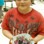 Kamdyn Doughty holds his pottery. As in Burke’s art, Doughty explored images and themes of spring.-Michael Armstrong, Homer News