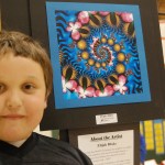Elijah Burke stands by his digital drawing, “The Spirals of Spring.” Burke made the art using a computer program that generates repeating patterns called fractals.-Michael Armstrong-Homer News