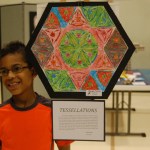 Morgen Techie stands by his painting, “Tesselations.” Many students explored geometric shapes in their art.-Michael Armstrong-Homer News
