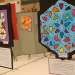 Other work in the art fair is shown. Olivia Etzwiler’s “Best Art Ever!” is at left and Mikayla Garza’s “The Colorful Hearts” is at right.-Michael Armstrong-Homer News