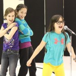 Clockwise, from left: Alayna Walker, Lauren Allen and Sailey Rhodes pour some energy into their dance routine.-Photo by McKibben Jackinsky, Homer News