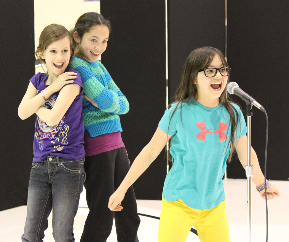 Clockwise, from left: Alayna Walker, Lauren Allen and Sailey Rhodes pour some energy into their dance routine.-Photo by McKibben Jackinsky, Homer News