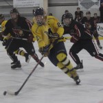 Mariner Tommy Bowe drives the puck down the rink and into Kenai Kardinal territory at Tuesday night’s game at the Kevin Bell Arena.-Photo by McKibben Jackinsky, Homer News