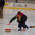 Michelle Hatten throws a stone during the curling demonstration. Hatten improvised a curling shoe by wrapping duct tape around the shoe.