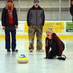 Liz Diament laughs as she throws a stone during a curling demonstration on Sunday. Diament slid the stone right on the center, or button, of the circular target. -Michael Armstrong-Homer News