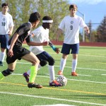 Nouredine Mama works to keep the ball away from an eager Colony player during the boy's varsity May 6 home game. Homer lost to Colony 2-0.-Photo by Anna Frost; Homer News
