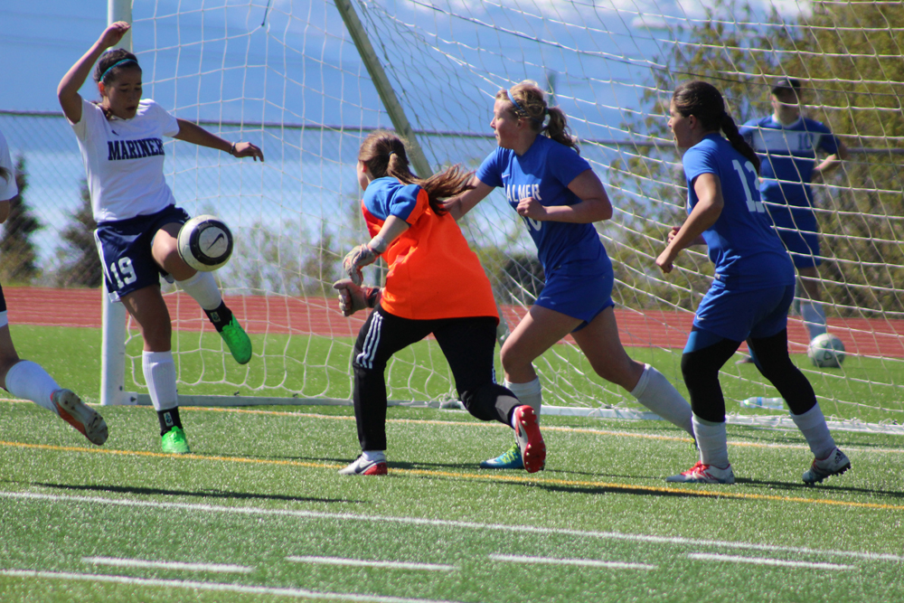 Kaela Jiron blocks a Palmer goal attempt in a single leap during the Mariners May 7 home game against Palmer.-Photo by Anna Frost, Homer News