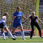 Rachel Ellert kicks the ball into the goal, despite Palmer defense and goalie efforts. The Mariner girls beat Palmer 7-1 on Saturday, May 7.-Photo by Anna Frost; Homer News