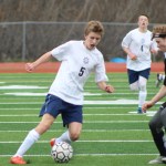 Simon Dye faces off against a Nikiski player for the ball during the Thursday, April 14 game held at Homer High School.-Photo by Anna Frost; Homer News