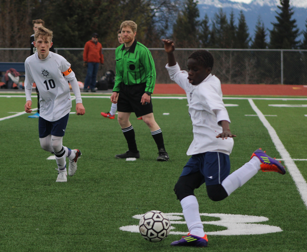 Nouredine Mama prepares to kick the ball across the field in attempt to get it closer to Nikiski's goal. Homer beat Nikiski 4-1 in the home game on Thursday, April 14.-Photo by Anna Frost; Homer News