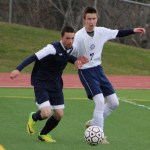 Jordan Beachy speds up to get past the Soldotna High players rushing toward the ball during the Tuesday, April 19 game at Homer High. Soldotna beat Homer by one point.-Photo by Anna Frost; Homer News