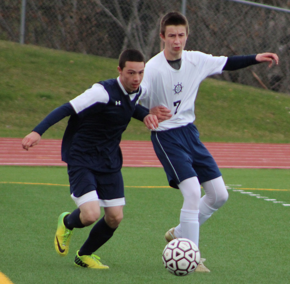 Jordan Beachy speds up to get past the Soldotna High players rushing toward the ball during the Tuesday, April 19 game at Homer High. Soldotna beat Homer by one point.-Photo by Anna Frost; Homer News