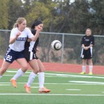 Brenna McCarron checks a Nikiski player as they both rush for the ball during the Thursday, April 14 game at Homer High School.-Photo by Anna Frost; Homer News