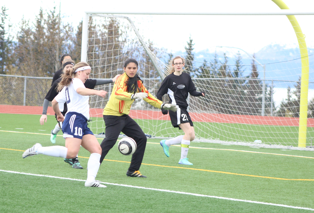 Uliana Reutov takes a shot at Nikiski's goal during the Thursday, April 14 game held at Homer High. Homer finished 4-0 against Nikiski, earning their first win at home.-Photo by Anna Frost; Homer News