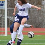 Alison McCarron leaps toward the ball as a Soldotna player kicks it away. Homer girls played Soldotna on Tuesday, April 19 and finished with a 3-0 loss.-Photo by Anna Frost; Homer News