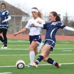 Rachel Ellert rushes the ball to steal it from a Soldotna player during the Tuesday, April 19 game at Homer High. -Photo by Anna Frost; Homer News