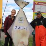 Ashley Camp, left, of Vancouver, British Columbia, Canada, poses with her 221.4-pound halibut caught on July 28, 2018 near Homer, Alaska. She caught the current Homer Jackpot Halibut Derby leader while fishing with Captain Brian Nollar, right, on the Bell Isles with Midnight Sun Charters. (Photo provided)