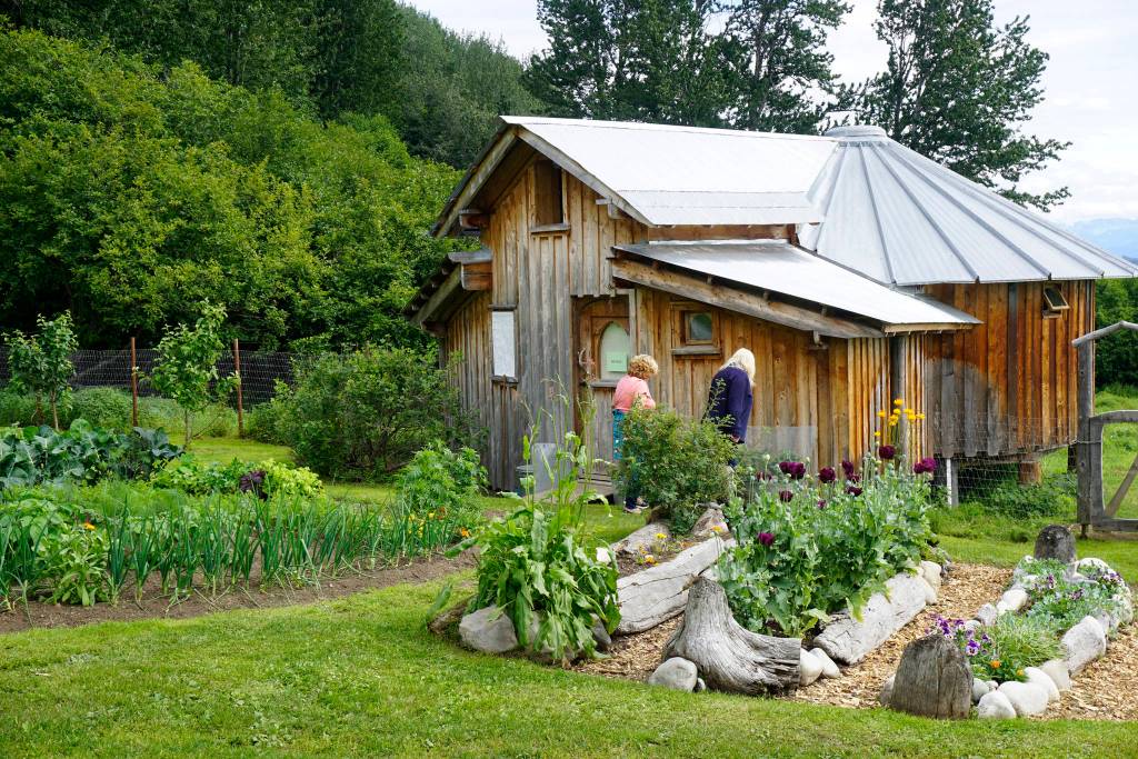 Drifwood and rock is used to line the gardens at the Jeff and Ranja Dean farm off East End Road in Homer, Alaska. It was one of five gardens featured in the July 29, 2018 Homer Garden Tour. (Photo by Michael Armstrong/Homer News)