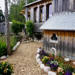 Drifwood and rock is used to line the gardens at the Jeff and Ranja Dean farm off East End Road in Homer, Alaska. It was one of five gardens featured in the July 29, 2018 Homer Garden Tour. (Photo by Michael Armstrong/Homer News)