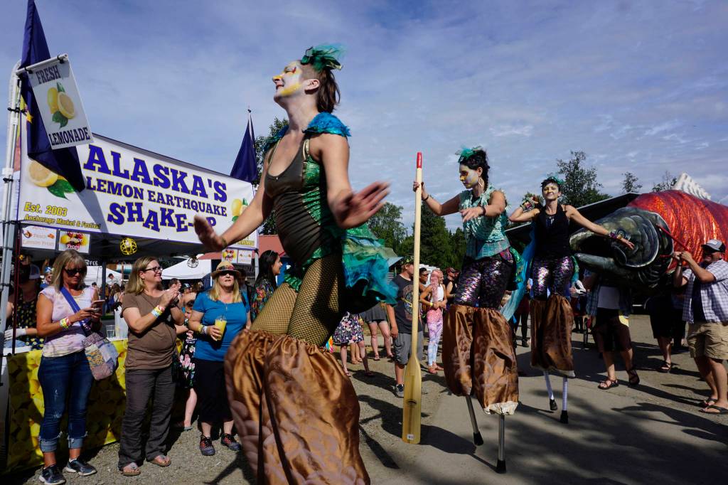 An art and music performance during Salmonfest on Saturday, Aug. 4, 2018, featured women on stilts dressed as mermaids, salmon sculptures and the LowDown Brass Band. Salmonfest attendees enjoyed warm sunny weather on Saturday at the Kenai Peninsula Fairgrounds in Ninilchik, Alaska. (Photo by Michael Armstrong/Homer News)