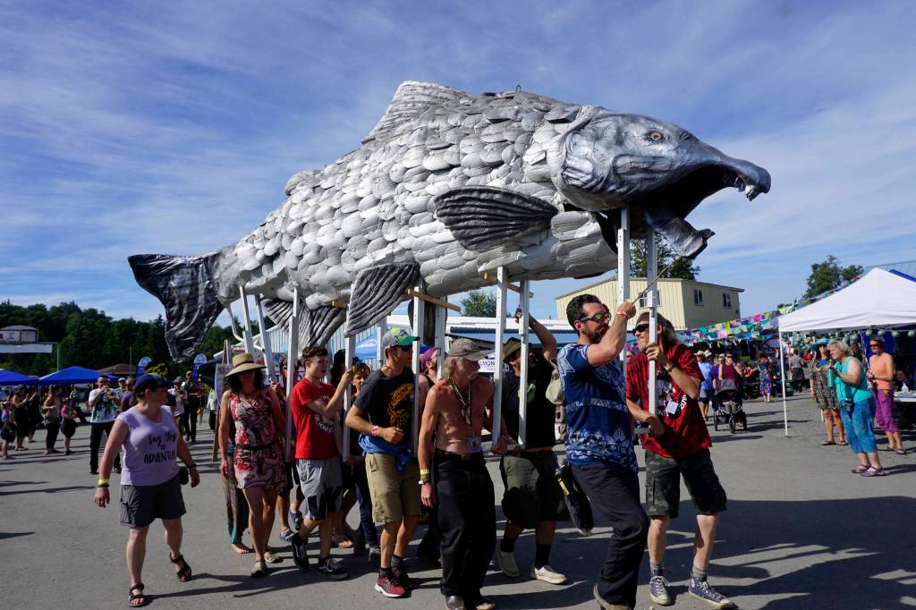 An art and music performance during Salmonfest on Saturday, Aug. 4, 2018, featured women on stilts dressed as mermaids, salmon sculptures and the LowDown Brass Band. Salmonfest attendees enjoyed warm sunny weather on Saturday at the Kenai Peninsula Fairgrounds in Ninilchik, Alaska. (Photo by Michael Armstrong/Homer News)