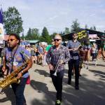 An art and music performance during Salmonfest on Saturday, Aug. 4, 2018, featured women on stilts dressed as mermaids, salmon sculptures and the LowDown Brass Band. Salmonfest attendees enjoyed warm sunny weather on Saturday at the Kenai Peninsula Fairgrounds in Ninilchik, Alaska. (Photo by Michael Armstrong/Homer News)