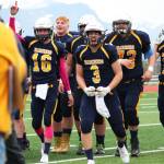 Justin Sumption (16) and Dawson Felde (3) come off the field celebrating with their teammates after defeating Ben Eielson High School in a playoff game Oct. 7, 2017 at Homer High School in Homer, Alaska. The Mariners went on to lose the ASAA First National Bowl Series Division III Championship game to the Barrow Whalers. (Photo by Megan Pacer/Homer News)