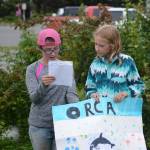At left, Jillian Tracy, 12, of Palmer, and Caroline Higgins, right, of Philadelphia, do a presentation on orca whales at the end of Marine Mammal Camp on Friday, Aug. 10, 2018, at the Center for Alaskan Coastal Studies in Homer, Alaska. The girls and other camps went to the camp at the Peterson Bay Field Station and then closed with talks on marine mammals. They also articulated a sea cat, or lynx, skeleton with bone expert Lee Post. (Photo by Michael Armstrong/Homer News)