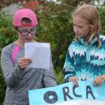 At left, Jillian Tracy, 12, of Palmer, and Caroline Higgins, right, of Philadelphia, do a presentation on orca whales at the end of Marine Mammal Camp on Friday, Aug. 10, 2018, at the Center for Alaskan Coastal Studies in Homer, Alaska. The girls and other camps went to the camp at the Peterson Bay Field Station and then closed with talks on marine mammals. They also articulated a sea cat, or lynx, skeleton with bone expert Lee Post. (Photo by Michael Armstrong/Homer News)