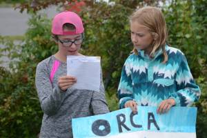 At left, Jillian Tracy, 12, of Palmer, and Caroline Higgins, right, of Philadelphia, do a presentation on orca whales at the end of Marine Mammal Camp on Friday, Aug. 10, 2018, at the Center for Alaskan Coastal Studies in Homer, Alaska. The girls and other camps went to the camp at the Peterson Bay Field Station and then closed with talks on marine mammals. They also articulated a sea cat, or lynx, skeleton with bone expert Lee Post. (Photo by Michael Armstrong/Homer News)