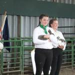 Three 4-H members show rabbits for market sale during the JML livestock auction Saturday, Aug. 18, 2018 at the Kenai Peninsula Fair in Ninilchik, Alaska. (Photo by Megan Pacer/Homer News)