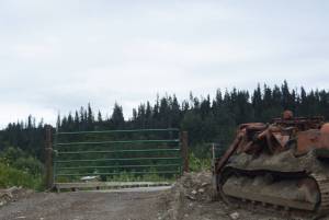 A gate on Aug. 18, 2018, blocks the bridge to the Glanville family homestead near Mile 164 Sterling Highway north of Homer, Alaska. Alaska State Troopers on Aug. 16 found a squatter, Keith Evans, 57, on the property when they went to serve a writ of assistance to evict him. (Photo by Michael Armstrong/Homer News)
