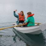 Jenya Anichenko waves as her daughter Tatiana Rogers rows a boat during the Kachemak Bay Wooden Boat Society Festival on Saturday, Sept. 2, 2017, at the Nick Dudiak Fishing Lagoon campground. (File photo by Michael Armstrong/Homer News)