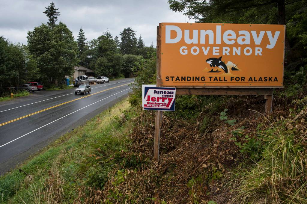 Mike Dunleavy for governor and Jerry Nankervis for state house election signs are seen on Egan Drive at 17 Mile on Friday, Aug. 24, 2018. Alaska statute states signs on private or commercial property cannot be located within 660 feet of a state-maintained road or with the purpose of their message being read from the main traveled way. (Michael Penn | Juneau Empire)