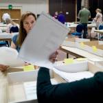 Elections workers hand count ballots after the 2016 statewide primary election. (Michael Penn | Juneau Empire)
