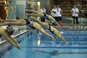 Swimmers from Homer, Kenai and Soldotna take off into the water during one of many events at the Homer Quad, held Friday, Aug. 24, 2018 at the Kate Kuhns Aquatic Center in Homer, Alaska. The Homer girls tied for second with Kenai. (Photo by Megan Pacer/Homer News)