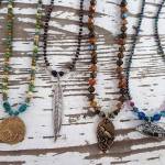 Liz Bowens dichroic glass and metal jewelry is featured in her new show opening Sept. 7, 2018, at the Art Shop Gallery, Homer, Alaska. (Photo provided)